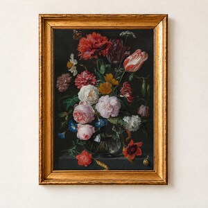 Vase of Flowers by Jan Davidsz de Heem as a framed print in an antique gold frame on a cream wall. A glass vase overflows with pink roses, striped tulips, red poppies and blue morning glories against a black background, a butterfly and a snail among the stems.