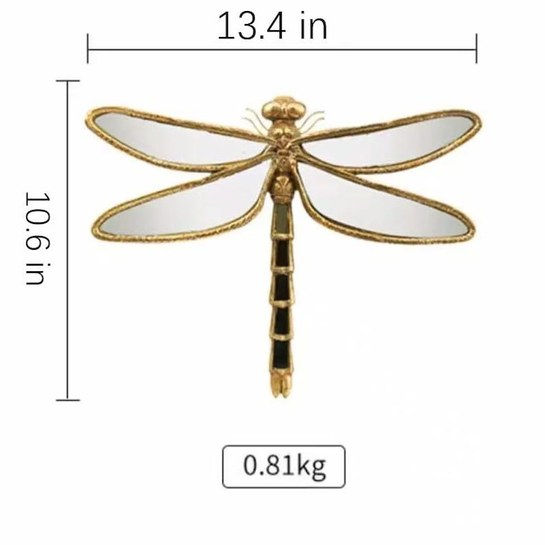 May include: A decorative dragonfly wall mirror with a gold-colored frame and mirrored wings. The dragonfly measures 13.4 inches wide and 10.6 inches tall, and weighs 0.81 kg.