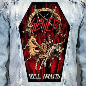 May include: A light blue denim jacket featuring a large, coffin-shaped back patch. The patch displays a red and black illustration with the text SLAYER at the top and HELL AWAITS at the bottom, depicting horned figures against a dark background.