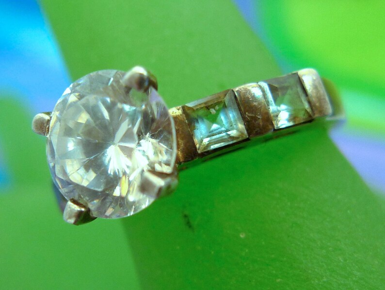 Size 7 Ring Engagement Cubic Zirconia and 4 Blue Topaz Baguettes Marked QJ 925 99.08
