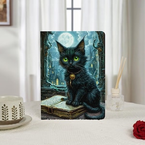 May include: A fantasy-themed notebook featuring a black cat with bright green eyes, wearing a gold pendant, sitting on an open book. The background depicts a moonlit cityscape with gothic architecture. The notebook is on a white surface.