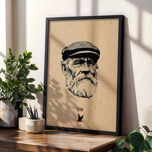 May include: Black and white framed print featuring a detailed illustration of an elderly man with a beard and cap. The artwork is set against a tan background with the number "1880" and a bird graphic. The frame is black.