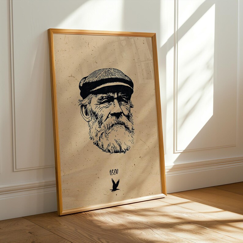 May include: Framed art print featuring a detailed black and white illustration of an elderly man with a beard and cap. The print is on a tan background with the year "1880" and a bird symbol at the bottom. The frame is a light brown color.