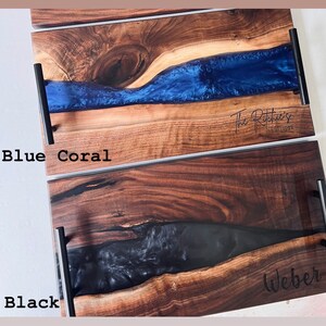 May include: Two wooden serving trays with black resin inlays. The top tray has a blue resin inlay and the text "The Ritchie's Est. 2003". The bottom tray has a black resin inlay and the text "Weber".