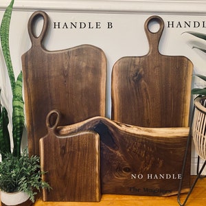 May include: Four wooden cutting boards, two with handles labeled "HANDLE A" and "HANDLE B", and one with no handle labeled "NO HANDLE The Wigners".