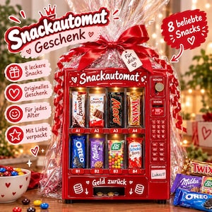 May include: A red toy vending machine gift set wrapped in clear cellophane with a red ribbon. The machine features eight slots containing various candy bars and snacks, a keypad, a coin slot, and the text Snackautomat and Geld zurück.