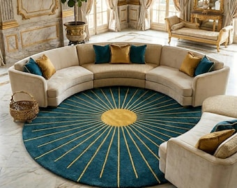 May include: A luxurious living room featuring a large, curved beige sofa with teal and gold accent pillows. A round teal rug with a gold sunburst design sits in the center. The room has marble flooring, gold accents, and large windows with cream-colored drapes.