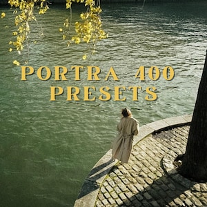 May include: A scenic image featuring the text "PORTRA 400 PRESETS" in gold lettering. A person in a tan coat stands on a stone walkway next to a river. Overhanging branches with yellow leaves frame the top of the image.