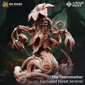 May include: A detailed, brown resin miniature of "The Thornmother, Corrupted Forest Sentinel." The figure has a floral head, leaf-like skirt, and vine-like arms ending in toothy maws. The base is a circular platform with the logos "DM STASH" and "A WILD HUNT."