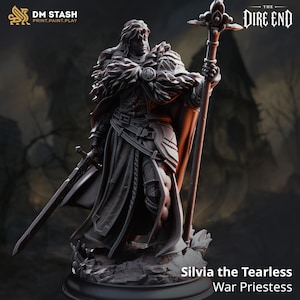 May include: A gray miniature figurine of a warrior figure named Silvia the Tearless, War Priestess. The figure wears a fur-lined cloak and armor, holding a long staff with a decorative top in one hand and a sword in the other, standing on a base.