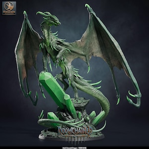 May include: A green dragon figurine with large, tattered wings, perched atop a cluster of bright green crystals on a rocky base. The base features the text "DOOMCHAINED" and the label "Adult Emerald Dragon - 75MM BASE" is visible below.