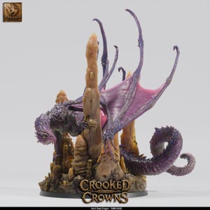 May include: A purple and tan dragon figurine with large wings and a long tail, positioned among tan rock formations on a 75mm base. The base features the text "CROOKED GOBLIN CROWNS" and the label "Adult Deep Dragon - 75MM BASE" at the bottom.