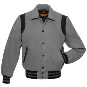May include: A gray varsity jacket with black accents on the shoulders, pockets, and cuffs. The jacket has a button-up front, a ribbed hem, and the brand name "NESTVOGUE GOODS" on the collar.