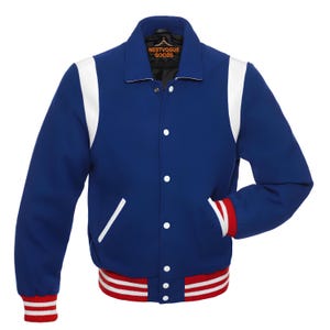 May include: A blue varsity jacket with white accents on the shoulders and pockets. The jacket has a white collar and white stripes on the sleeves and bottom hem. The cuffs and hem feature red and white stripes. The jacket has the text "NESTVOGUE GOODS" on the inside collar.