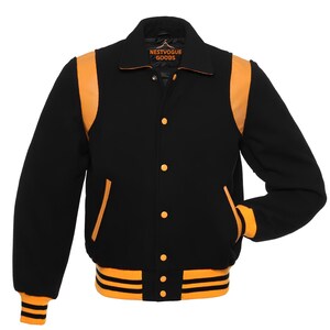 May include: Black varsity jacket with orange accents on the shoulders, pockets, and cuffs. The jacket features a button-up front and a ribbed hem with orange and black stripes. The collar has the text "NESTVOGUE GOODS".