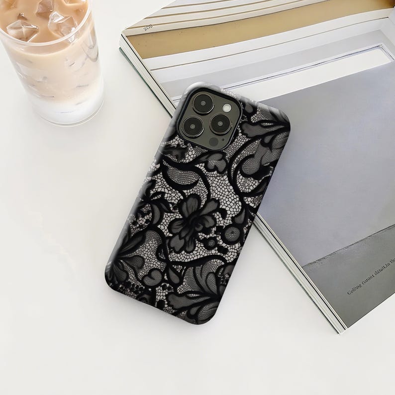 The Vintage Lace Phone Case features an elegant black flower design with intricate lace details, combining classic vintage charm with modern protection. Made from durable materials, it shields your phone from daily drops and scratches. Slim, lightweight, and comfortable to hold, it keeps your device safe without bulk. Compatible with iPhone 12–17 Plus/Pro Max and Samsung S22–S25 Plus/Ultra, perfect for those who love timeless elegance.