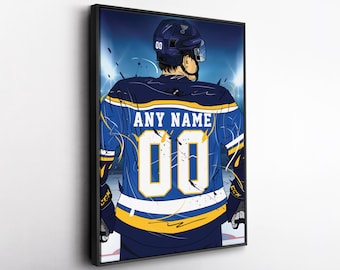May include: A framed illustration of a hockey player from the back, wearing a blue jersey with the text "ANY NAME" and the number "00". The jersey has yellow accents. The player is wearing a helmet and is on the ice.