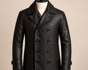 May include: A black double-breasted leather pea coat featuring a wide notched collar, eight front buttons arranged in two vertical rows, and adjustable buttoned straps on the cuffs. The coat is displayed on a mannequin torso.