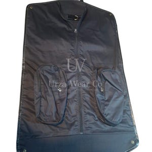 May include: A black garment bag featuring a central vertical zipper, two exterior zippered pockets, and a top hanging loop. The text "UV" and "Urza Wear Co" are printed in white on the front surface of the bag.