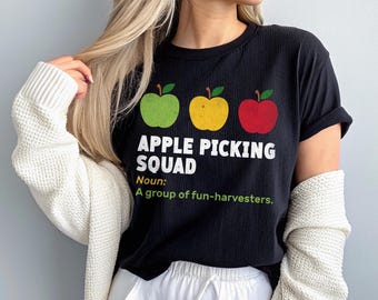 May include: Black t-shirt with the text "APPLE PICKING SQUAD" and three apple graphics in green, yellow, and red. The shirt also includes the definition: "A group of fun-harvesters."