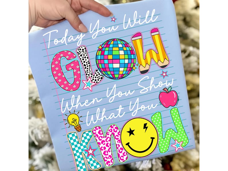 May include: Light blue notebook paper-style design with the text "Today You Will GLOW When You Show What You KNOW." Features a disco ball, pencils, apple, lightbulb, and smiley face graphics. The word "GLOW" has a pink and black polka dot pattern.