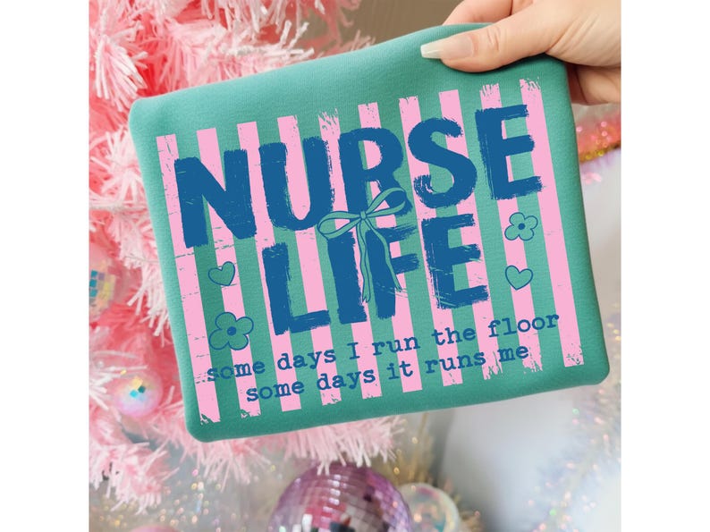 May include: Teal square pillow with pink vertical stripes and the words "NURSE LIFE" in blue. The text "some days I run the floor, some days it runs me" is also printed on the pillow. Decorative hearts and flowers are also included.