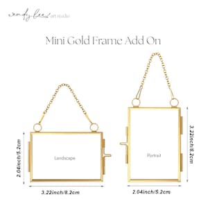 May include: Two gold-colored mini picture frames, one landscape and one portrait, with chain hangers. The landscape frame measures 3.22 inches by 2.04 inches, and the portrait frame is 2.04 inches by 3.22 inches.