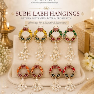 May include: A selection of Subh Labh Hangings in shades of yellow, green, orange, and red. Each piece has a circular design with detailed embellishments and a pearl tassel. The text "SUBH LABH HANGINGS" is displayed.