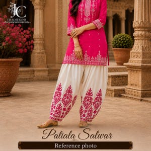 May include: A bright pink tunic featuring white floral embroidery along the neckline, sleeves, and hem, paired with off-white Patiala salwar pants that display matching pink floral embroidery patterns on the lower legs and gold-toned flat shoes.
