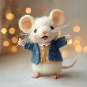 May include: A handcrafted felt mouse figurine with a cream-colored body, large pink ears, and a friendly expression. It wears a blue jacket over a tan vest, with tiny gold buttons. The mouse has pink paws and a long, pink tail.