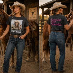May include: A charcoal gray t-shirt featuring a graphic print of a person in a cowboy hat with the text "BORN TO BE DIFFERENT" on the front and the text "ESCAPE THE MATRIX" in pink lettering on the back, paired with dark blue denim jeans.