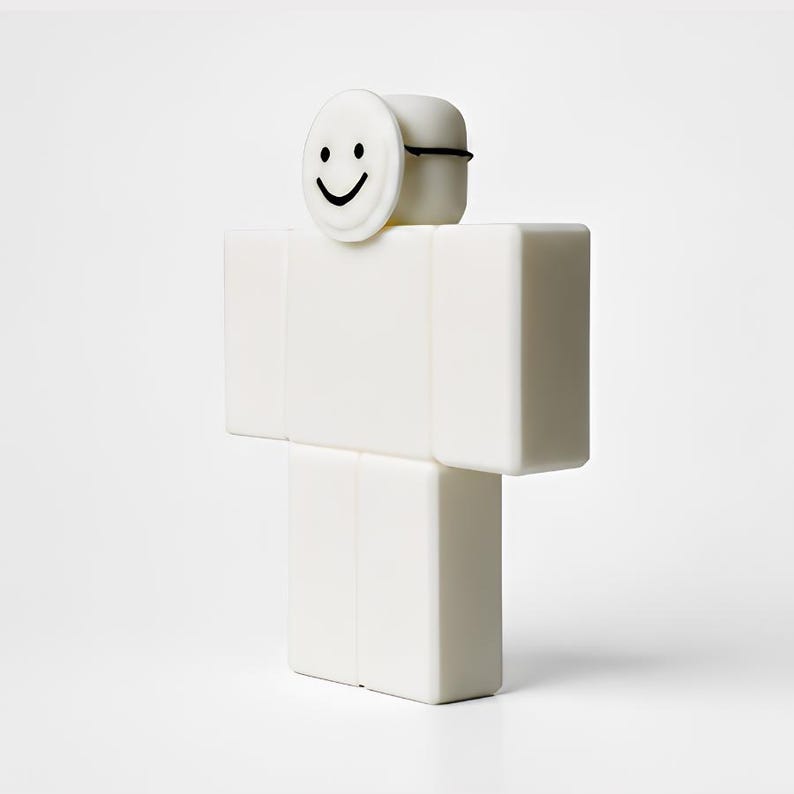 Puede incluir: Una figura blanca en forma de bloque con una cara sonriente en la parte superior. La figura es de color blanco s&oacute;lido, con una l&iacute;nea negra alrededor de la parte superior de la cabeza. La cara es un c&iacute;rculo blanco con una cara sonriente negra.