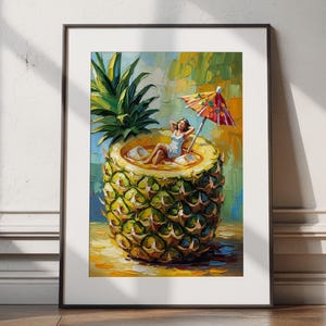 May include: A framed art print shows a woman relaxing inside a pineapple, complete with a miniature umbrella. The artwork uses a vibrant palette of greens, yellows, and blues, creating a tropical and whimsical scene. The woman is wearing a white dress.