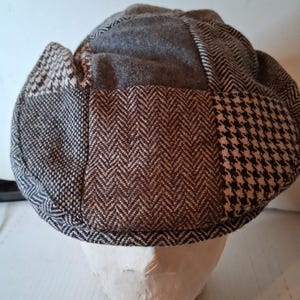 May include: A white ceramic mug with a black handle and the text "But First, Coffee" in a black, bold font. The mug is sitting on a wooden surface. The mug is 4 inches tall.