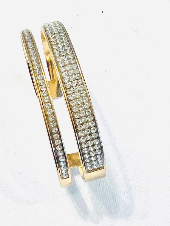 Rigid gold tone bangle bracelet
