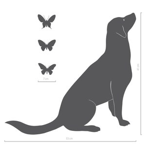 May include: A dark gray silhouette of a dog sitting and looking upward, accompanied by three small butterfly silhouettes. The dog measures 16.14 inches in height and 20.87 inches in length, while the butterflies measure 2.76 inches in width.