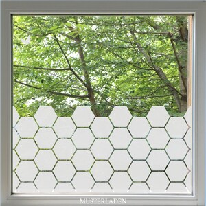 Privacy film with hexagon shapes in a regular pattern is applied to the window. The design is covering about the bottom half of the window. The design is centered.