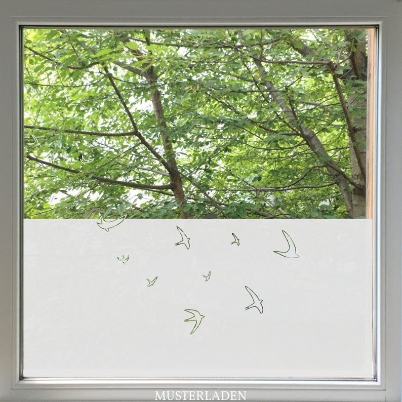 Flying birds window film is covering half the window. The outlines of the birds are cut out.