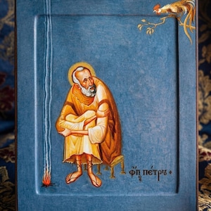 May include: A religious icon featuring a seated figure in a yellow robe, with a halo, and a long white beard. A rooster perches on a branch in the upper right corner. The background is a textured blue.