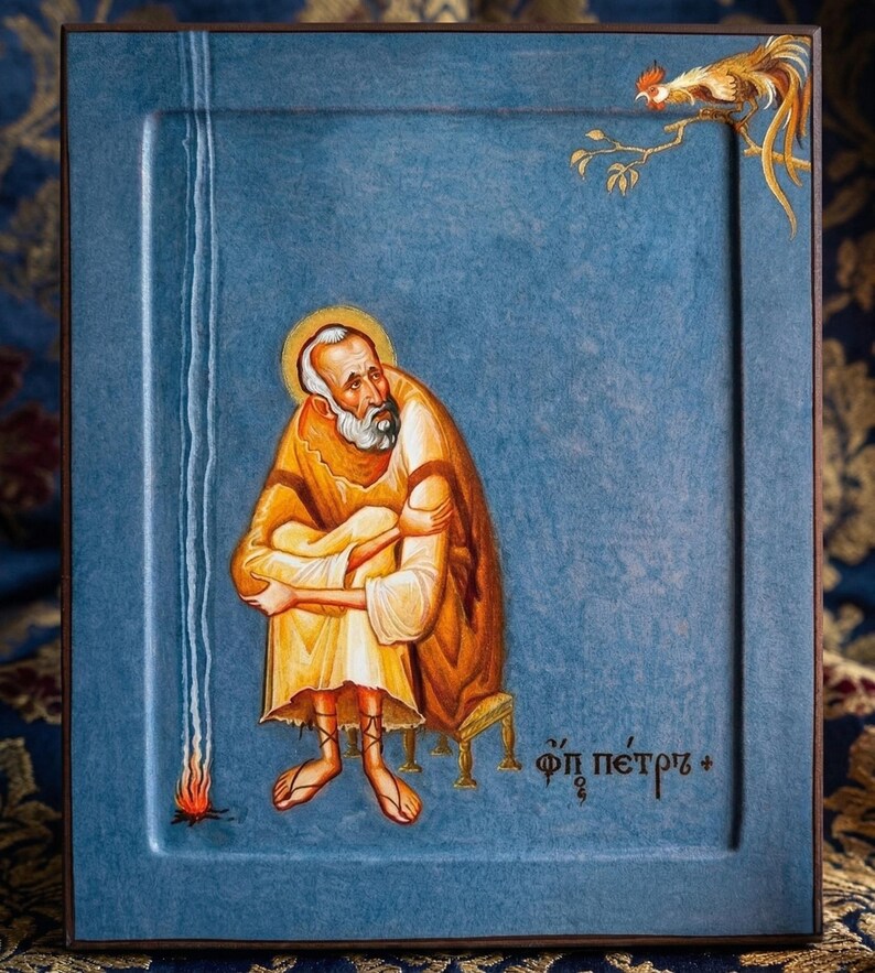 May include: A religious icon featuring a seated figure in a yellow robe, with a halo, and a long white beard. A rooster perches on a branch in the upper right corner. The background is a textured blue.