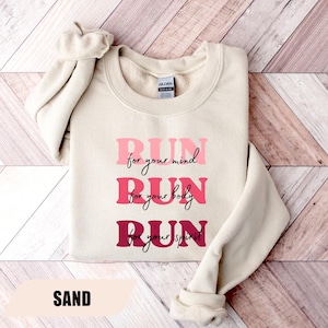 May include: A set of three ceramic mugs with a speckled, matte finish. The mugs are in shades of cream, light gray, and dark gray. Each mug has a simple, minimalist design, perfect for coffee or tea.