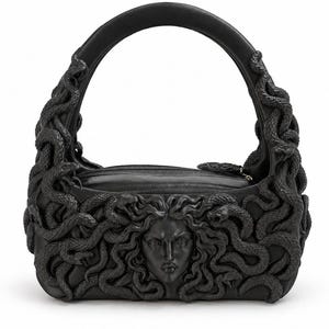May include: A black handbag featuring a sculpted Medusa face at the centre, surrounded by intricate, raised snake motifs that extend along the sides and up the integrated handle. The bag has a smooth, matte finish and a zippered top closure.
