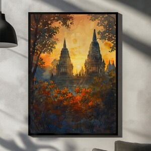 Peut inclure: Impression d'art encadrée représentant une peinture à l'aquarelle de temples anciens au coucher du soleil. L'œuvre d'art présente deux hautes structures ornées avec des flèches pointues, entourées d'un feuillage luxuriant aux tons orange, rouge et vert. Le ciel est un mélange chaleureux d'orange et de jaune.