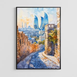 May include: Watercolour painting depicting a city street scene with modern skyscrapers and historic buildings. The artwork shows a cobbled street, stone walls, and a blue sky. The painting is framed in a black border.