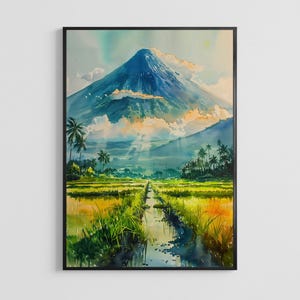 May include: Watercolor painting of a mountain landscape with a black frame. The artwork depicts a blue mountain, green fields, palm trees, and a stream. The sky has a mix of blue, yellow, and white hues.