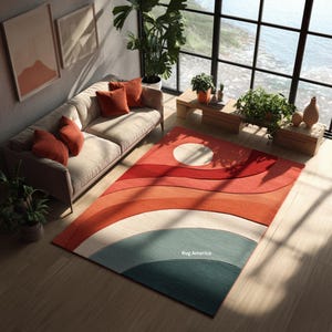 Könnte beinhalten: Ein rechteckiger Teppich mit Retro-Design. Der Teppich hat einen Farbverlauf aus Rot, Orange, Weiß und Blaugrün mit einem großen weißen Kreis in der oberen Ecke. Der Text "Rug America" ist auf dem Teppich zu sehen.