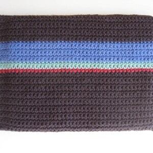 May include: A brown crocheted bag with blue, green, and red stripes.