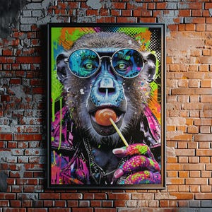 May include: A framed pop art print of a monkey wearing sunglasses and a leather jacket, licking a lollipop. The artwork features vibrant colors, including neon green, pink, and blue, against a brick wall background.