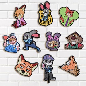 May include: A collection of colorful cartoon character stickers featuring a fox, a rabbit, a beaver, and other animal characters. The stickers are in various poses and outfits, with some wearing uniforms.