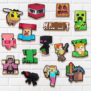 May include: A collection of colorful, pixelated character and object designs, including a bee, TNT block, and a green Creeper. The designs are reminiscent of a popular video game and are arranged against a white brick background.